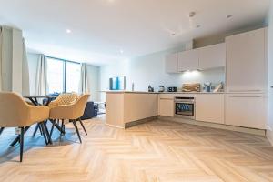 a kitchen and dining room with a table and chairs at Luxurious 1 Bed - CITY VIEW in Liverpool