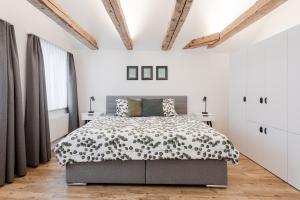 a bedroom with a bed with a black and white comforter at Dein Zuhause in Herisau in Herisau