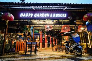 een scooter geparkeerd voor een gelukkige tuin en revisie winkel bij Happy Garden Resort Betong in Betong