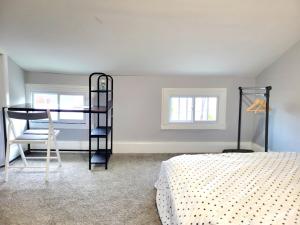 a bedroom with a black bunk bed and a chair at Budget Bed Room near Downtown Inner Harbor w Free Parking in Baltimore