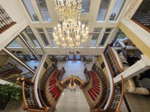 an overhead view of a staircase in a building with a chandelier at Empress Palace Hotel in Surrey