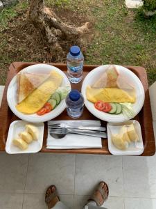 a table with three plates of food on it at BESAKIH HOMESTAY in Karangasem