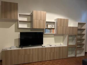 a large entertainment center with a flat screen tv at Villa Tirotti in Piacenza