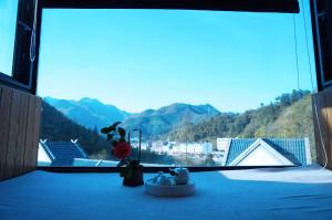 a window with a view of a mountain view at Villa EN Emerald Valley, Huangshan in Huangshan Scenic Area