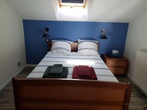 a bedroom with a bed with three towels on it at 9 pers 160 M² +jardin- 10mn Nantes -30mn mer in Bouguenais