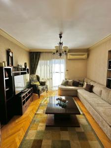 uma sala de estar com um sofá e uma mesa em Cozy flat in Bolkly-Alexandria em Alexandria