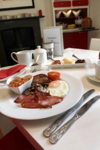 a plate of breakfast food on a table at Bedlam House in Newquay