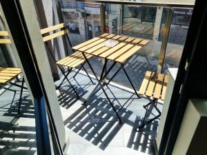 a table and chairs sitting on a balcony at Xelibri Apartment in Gorna Oryakhovitsa