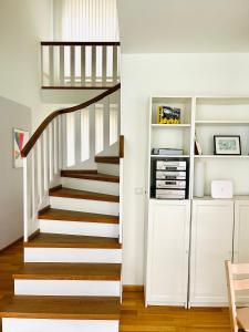 a staircase in a home with white walls and wooden floors at Elegantes Haus - direkt am Domplatz - Garage in Erfurt
