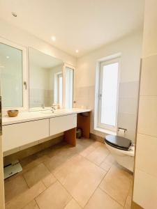 a bathroom with a toilet and a sink and a mirror at Elegantes Haus - direkt am Domplatz - Garage in Erfurt