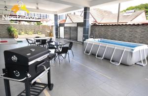 a swimming pool and a hot tub on a house at Tengkera Hidden Gem Villa Malacca City By Nestcove in Malacca
