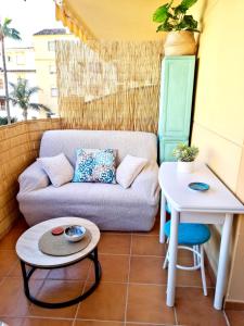 a living room with a couch and a table at Casa Oikos - La Cala de Mijas in La Cala de Mijas