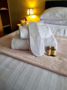a bed with towels and two bottles of medicine on it at HEWORTH INN and ROOMS in York