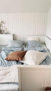 a bed with two pillows on top of it at SeaSide in Hjälteby