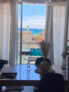 a dining room table with a view of the ocean at Appartement vue mer accès plage in Antibes
