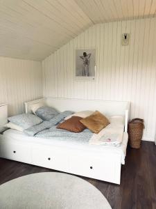 a large white bed in a room with at SeaSide in Hjälteby