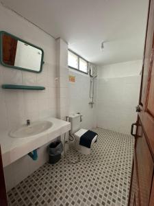 a bathroom with a sink and a toilet at THADAN GUEST HOUSE in Ban Houayxay