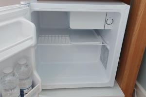 an open refrigerator with bottles of water in it at The Studio in Kildare