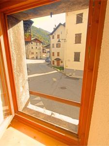 a view from a window of a street at Casa Colibrì - Welcome to a Mountain Dream in Forni di Sopra