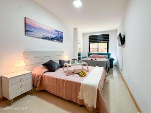 a bedroom with two beds and a couch at Bga Rentals Garbi in Cambrils +17 photos