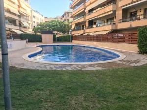 a large pool in the middle of a building at Bga Rentals Garbi in Cambrils
