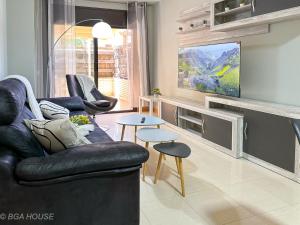 a living room with a couch and a tv at Bga Rentals Garbi in Cambrils