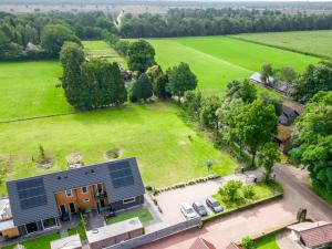 una vista aérea de una casa con paneles solares en un campo en B&B Speulderveld, en Ermelo