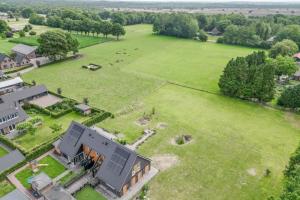 an aerial view of a house with a large field at B&B Speulderveld in Ermelo