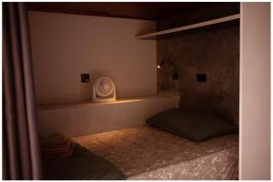 a room with a bed with a pillow and a lamp at Blue Chitta Yoga & Freediving in Koh Tao +32 photos