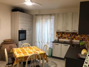 a kitchen with a table and a kitchen with a table and chairs at Alloggio Turistico Pratoterra in Bracciano