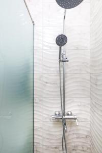a shower with a shower head in a bathroom at Studio Maria- Prime Location in Kapana District in Plovdiv