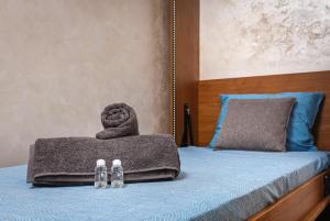 a bed with a towel and pair of shoes on it at Studio Maria- Prime Location in Kapana District in Plovdiv