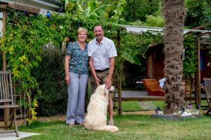 a man and a woman standing next to a dog at La Girouardière in La Flèche