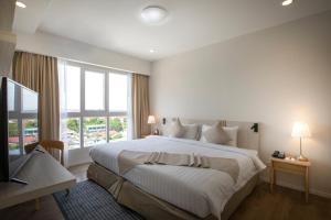 Postel nebo postele na pokoji v ubytování Kantary Hotel Banchang