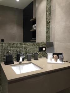 a bathroom counter with a sink and a mirror at Sleep at Sea in Nieuwpoort +14 photos