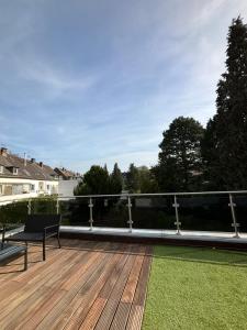 una terraza con un banco en la parte superior de una casa en Lenti Düsseldorfer Apartment’s en Düsseldorf