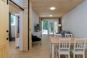 a dining room and living room with a table and chairs at Apartamentos El Bosque De Cubas in Cubas