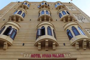 a building with blue windows and a hotel window palace at Hotel Vivan Palace in Jaisalmer