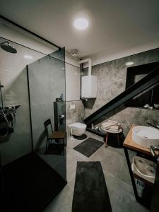 a bathroom with a staircase and a sink and a toilet at Morandini Apartments in Čakovec