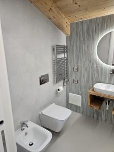 a bathroom with a white toilet and a sink at Otium Relais in Furore