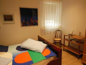 a bedroom with a bed and a desk and a chair at AVD - La Nuova Casa di Nonna in Udine