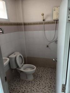 a bathroom with a toilet and a sink and a shower at Center Place Ang Thong 