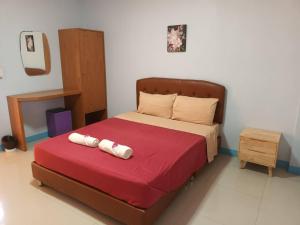 um quarto com uma cama com duas toalhas em Center Place Ang Thong 