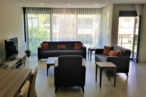 a living room with a couch and chairs and a tv at 10 Central Location, Close To Beaches And Anywhere in Antalya