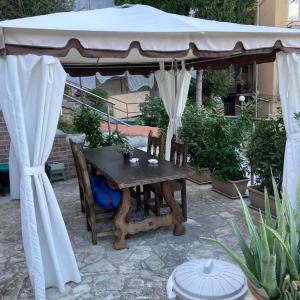 a gazebo with a table and chairs under it at Piccola Suite in Chieti