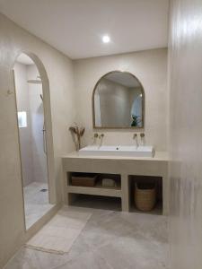 a bathroom with a sink and a mirror at La Suite du clocher in Noves