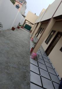 two pictures of a house and a driveway at Panipat Town House panipath in Pānīpat