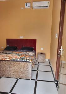 a bedroom with a bed and a tiled floor at Panipat Town House panipath in Pānīpat