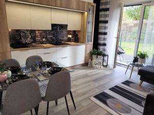 a kitchen and dining room with a table and chairs at Apartament Nina in Jelenia Góra