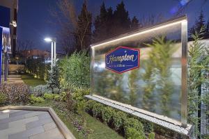 a sign for a pharmacy in a garden at night at Hampton by Hilton Istanbul Atakoy in Istanbul